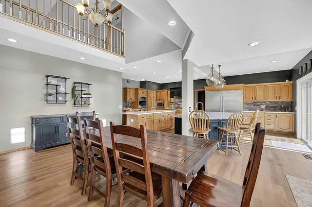 a dining room with a wooden table and chairs