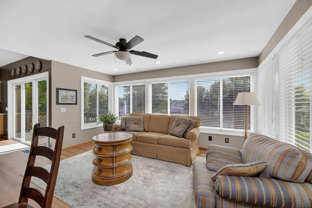 a large kitchen with kitchen island white cabinets and stainless steel appliances