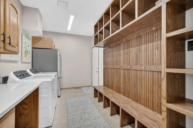 a spacious bathroom with a double vanity sink a mirror and a bathtub
