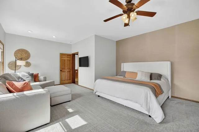 a view of a hallway with wooden floor and stairs