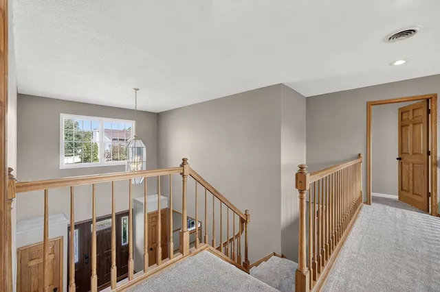 a bedroom with a bed a piano and a chandelier