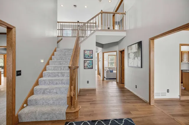 a view of entryway and hall with wooden floor