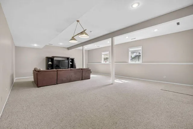 a backyard of a house with plants and large trees