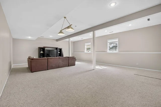 a backyard of a house with plants and large trees