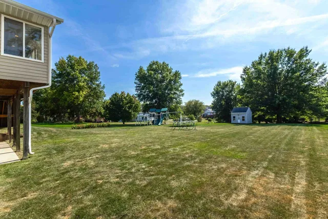 an aerial view of a city with lots of residential buildings and mountain view in back