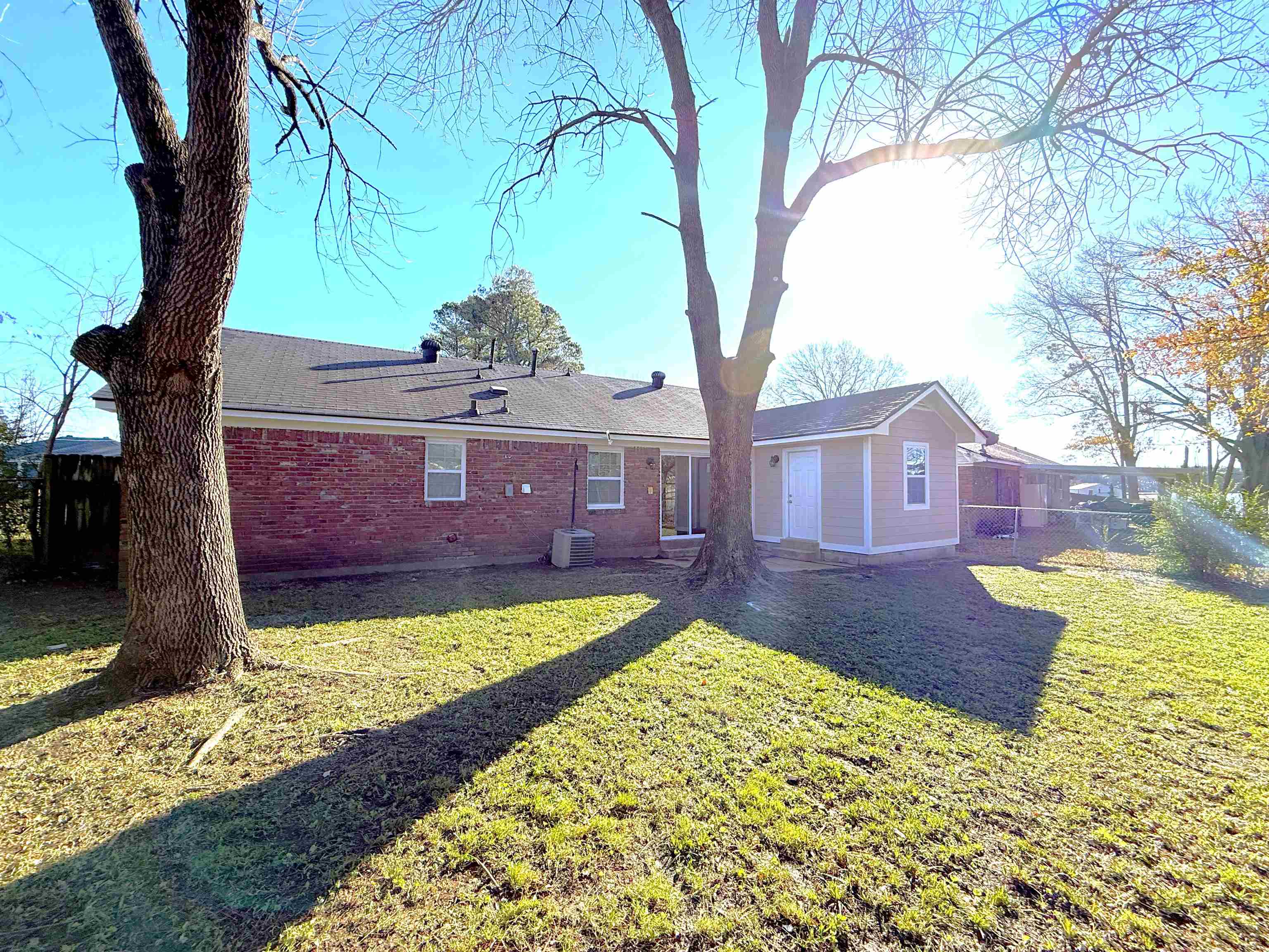 5165 Sea Shore Road Memphis, TN 38109 - Photo 18 of 20 Rear view of property with brick siding and a shingled roof