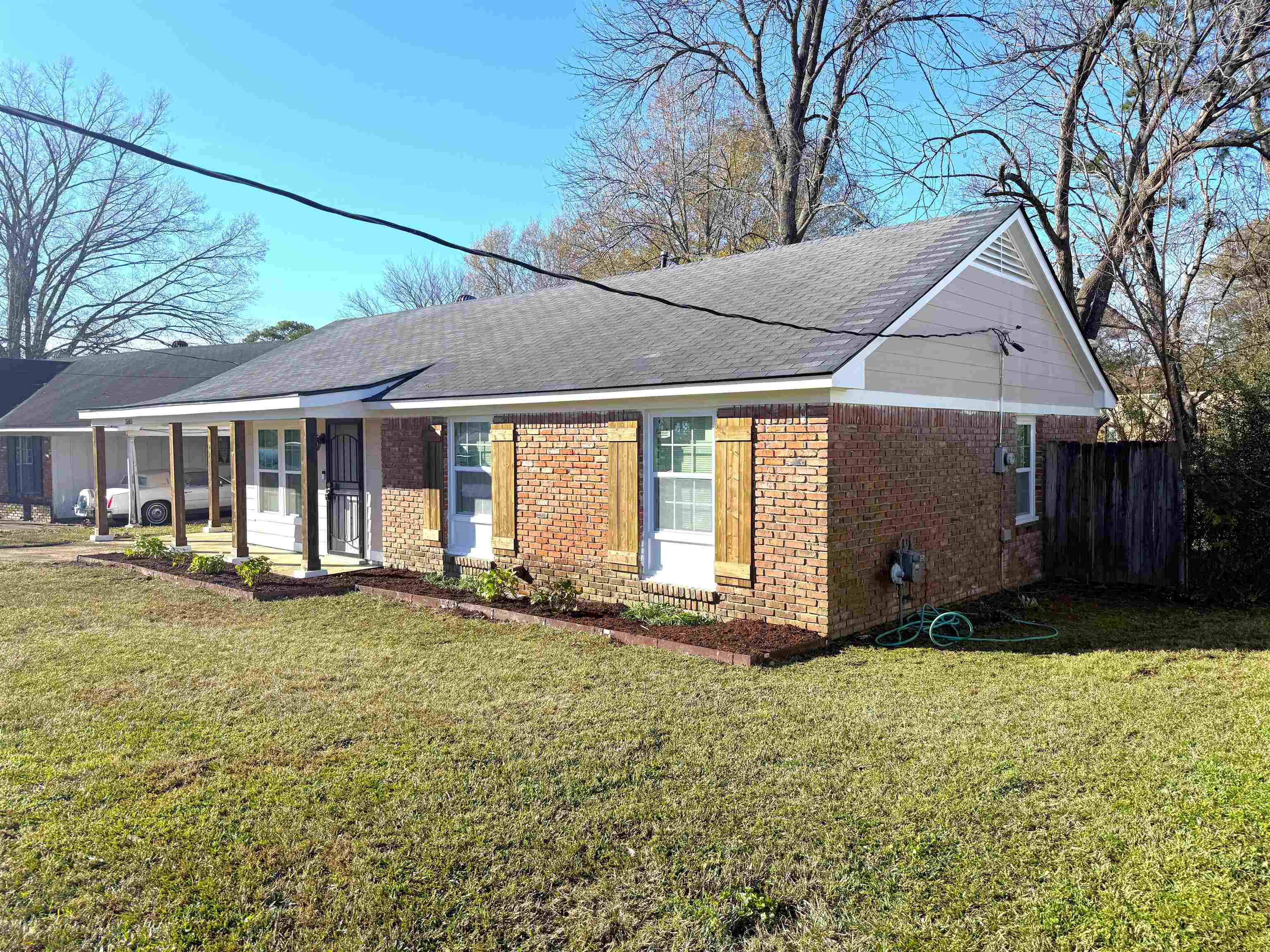 5165 Sea Shore Road Memphis, TN 38109 - Photo 20 of 20 View of front of property with brick siding, a porch, and a shingled roof