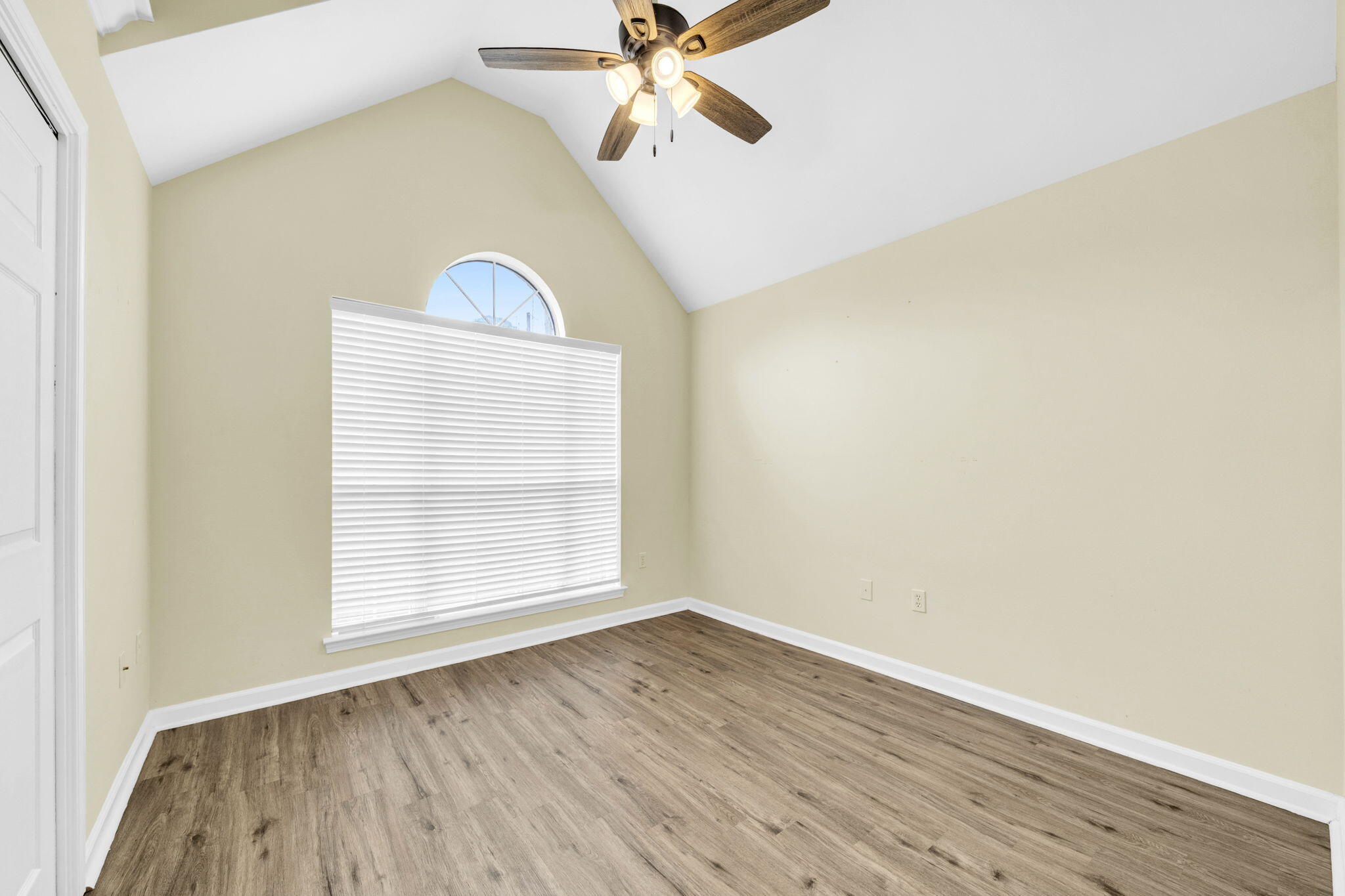 59 Hidden Lakes Drive Destin, FL 32550 - Photo 11 of 39 an empty room with wooden floor fan and windows