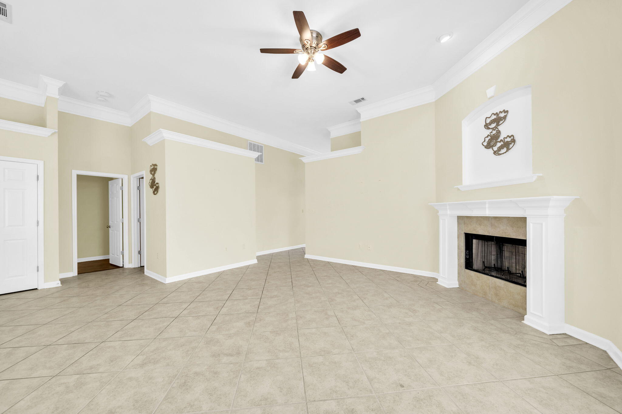 59 Hidden Lakes Drive Destin, FL 32550 - Photo 16 of 39 an empty room with a fireplace and a ceiling fan