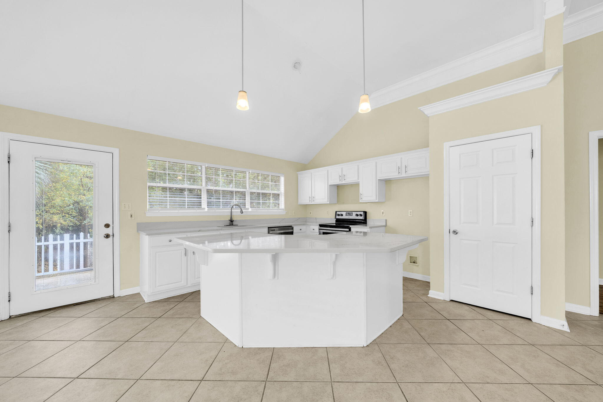 59 Hidden Lakes Drive Destin, FL 32550 - Photo 20 of 39 a view of a kitchen with kitchen island a sink a counter top space and appliances