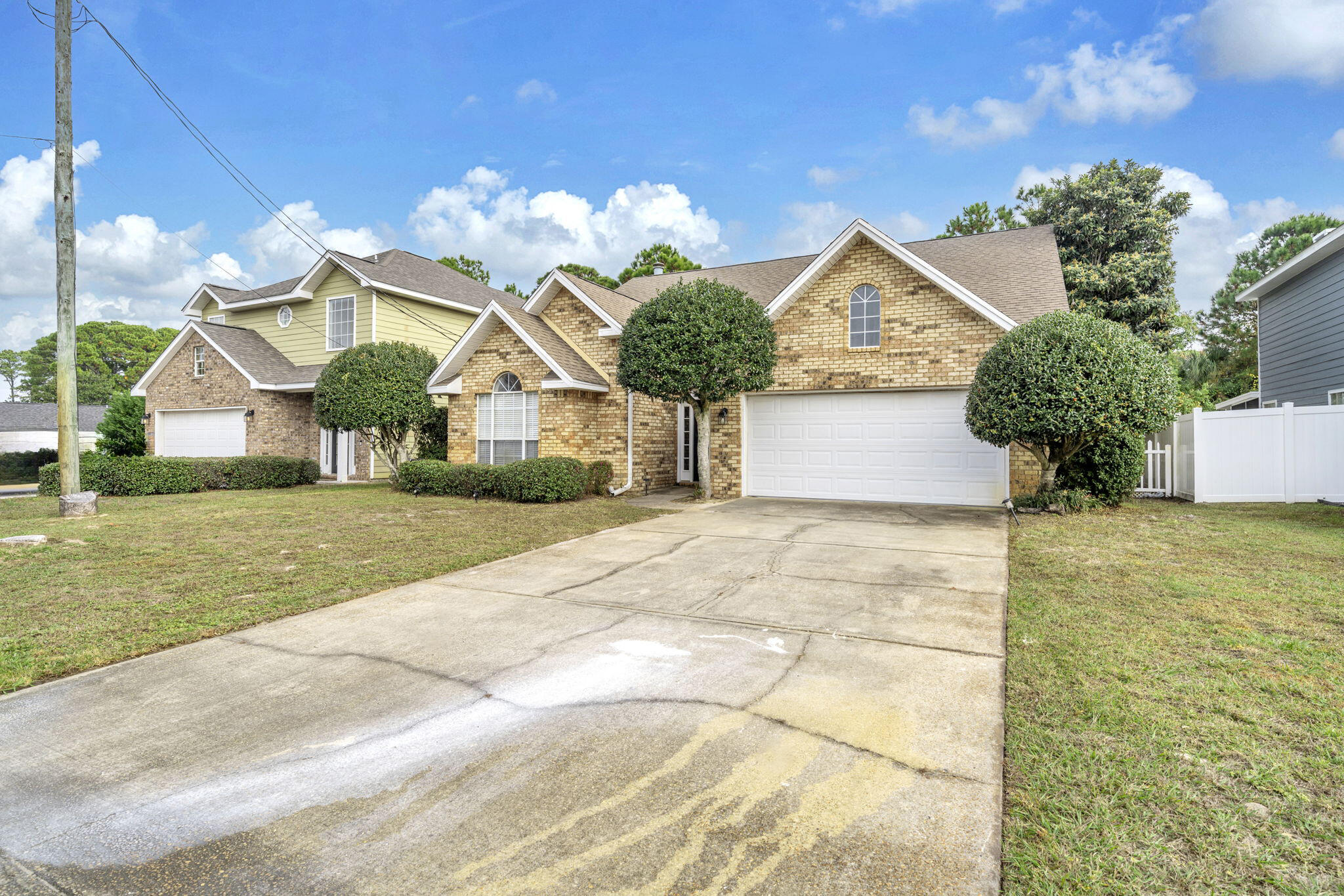 59 Hidden Lakes Drive Destin, FL 32550 - Photo 2 of 39 a front view of a house with garden