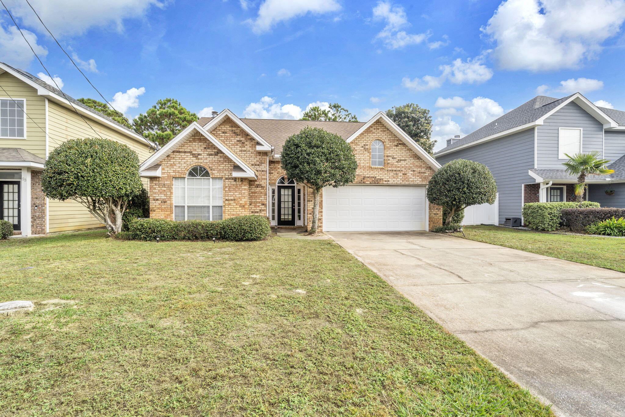 59 Hidden Lakes Drive Destin, FL 32550 - Photo 3 of 39 a front view of a house with a yard and garage