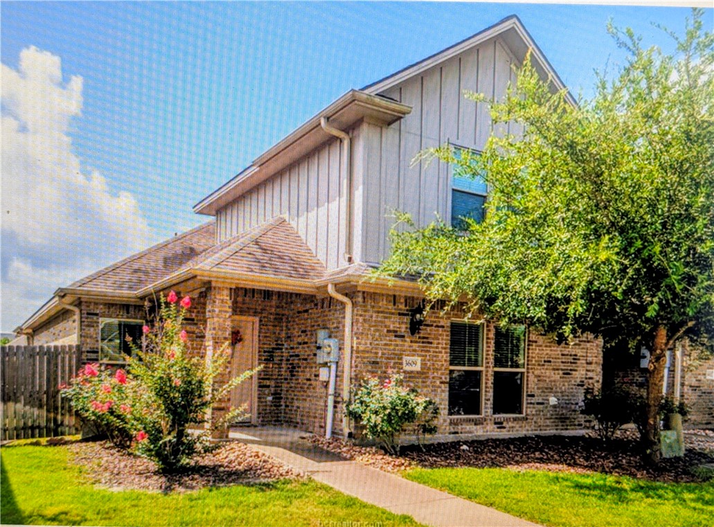 a front view of house with yard and outdoor seating