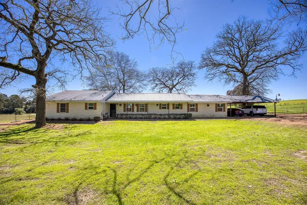 a house with swimming pool in front of it