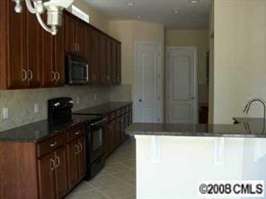 1428 Secret Path Drive, Unit 212 Fort Mill, SC 29708 - Photo 3 of 7 a kitchen with a sink and cabinets