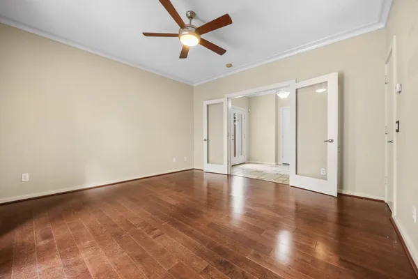 a view of an empty room with wooden floor