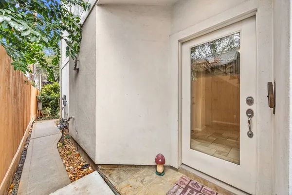 a view of entryway with white walls and open door