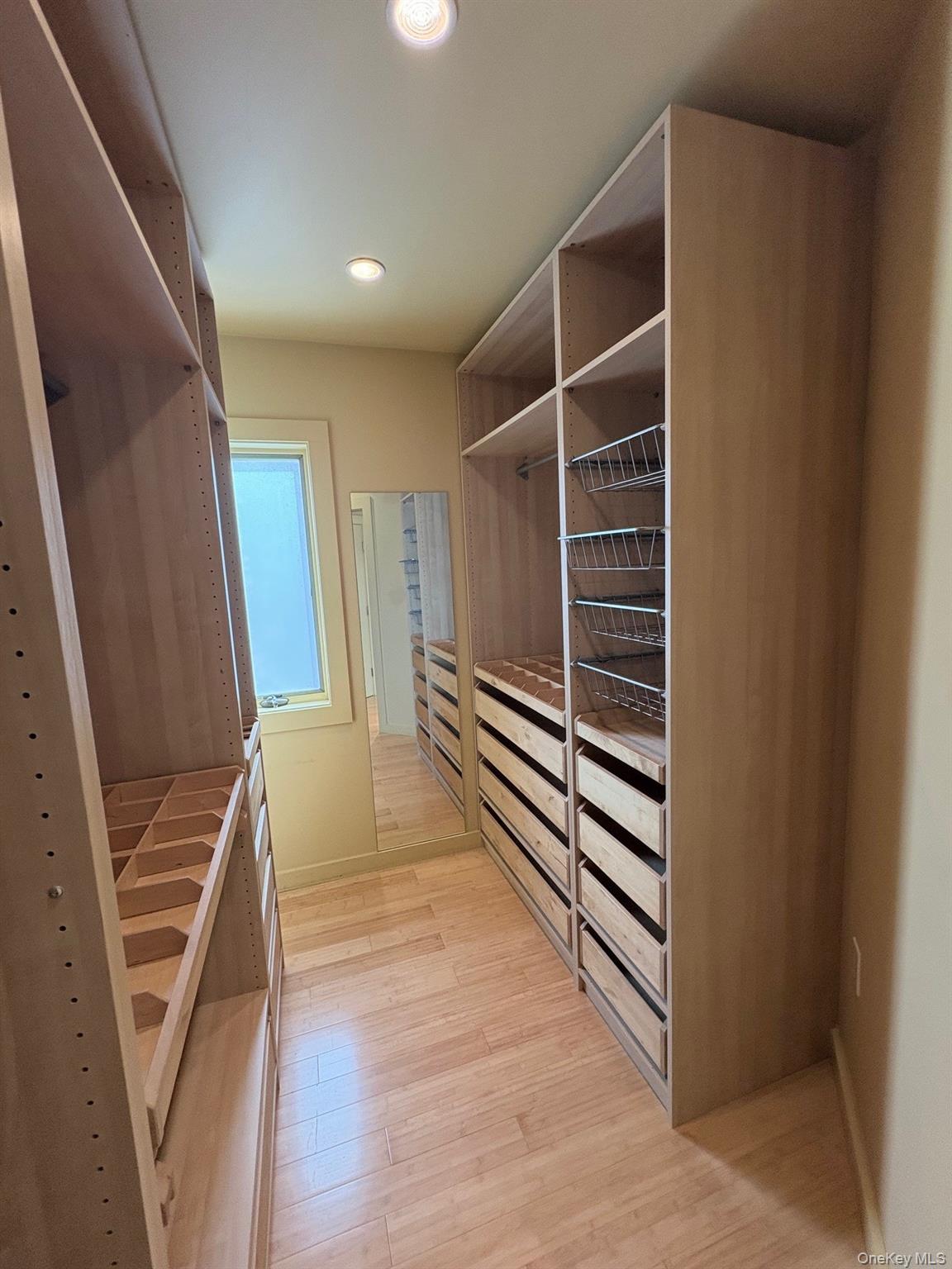1 Dale Street Rye, NY 10580 - Photo 21 of 28 Second walk-in closet in primary bedroom features a window and wall-mounted mirror.