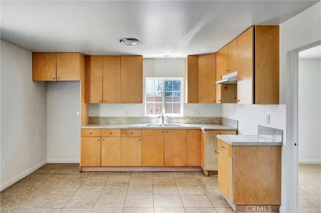 a kitchen with stainless steel appliances granite countertop a sink and cabinets