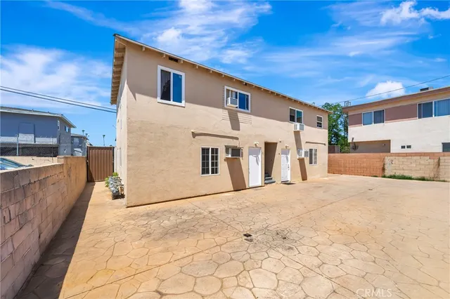 a view of a white house with a large space