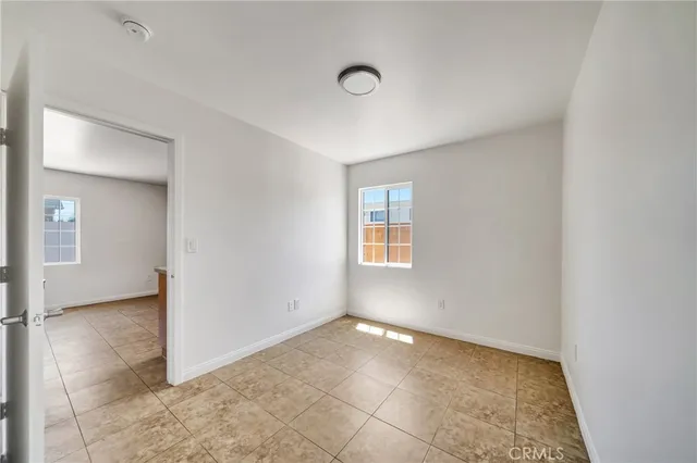 an empty room with windows and closet