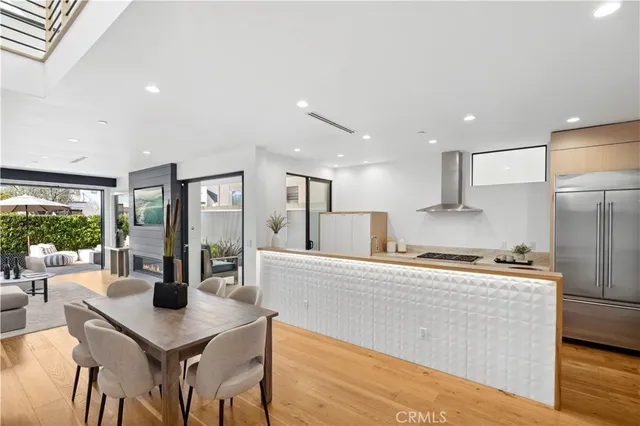 a kitchen with a sink a counter top space and living room view