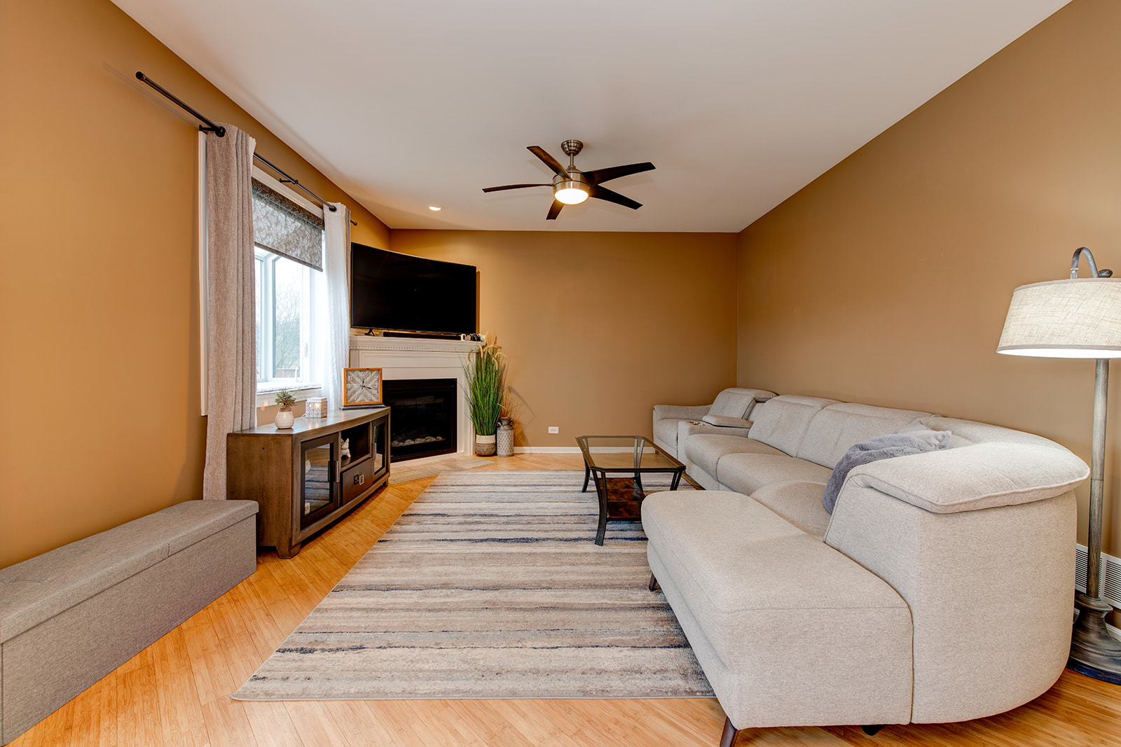 866 Deer Path Drive Antioch, IL 60002 - Photo 10 of 28 a living room with furniture a fireplace and a flat screen tv