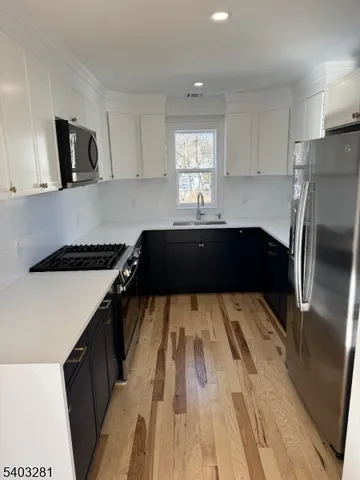 a kitchen with a refrigerator and a stove top oven