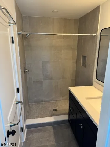 a bathroom with a shower and a sink