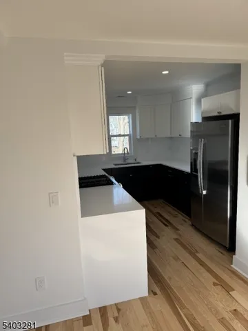 a kitchen with a sink and a refrigerator
