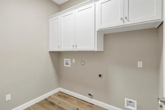 an empty room with a chandelier fan and closet