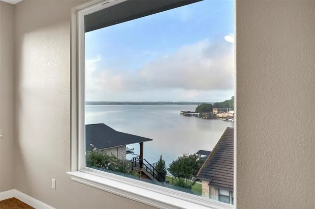 an aerial view of a house with pool lake view and mountain view