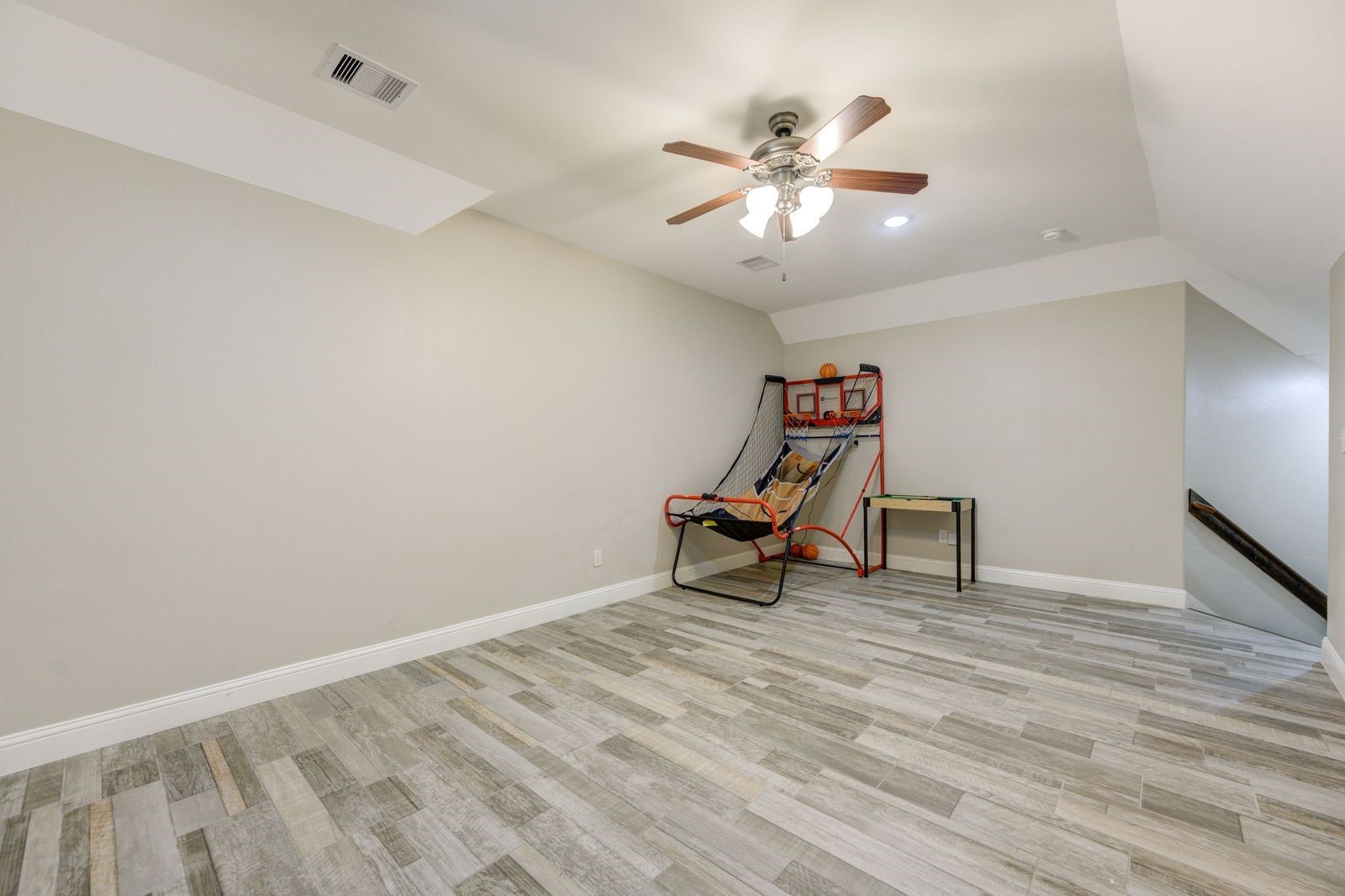 21038 Angus Drive Cleveland, TX 77328 - Photo 31 of 49 a view of a room with wooden floor a ceiling fan and windows