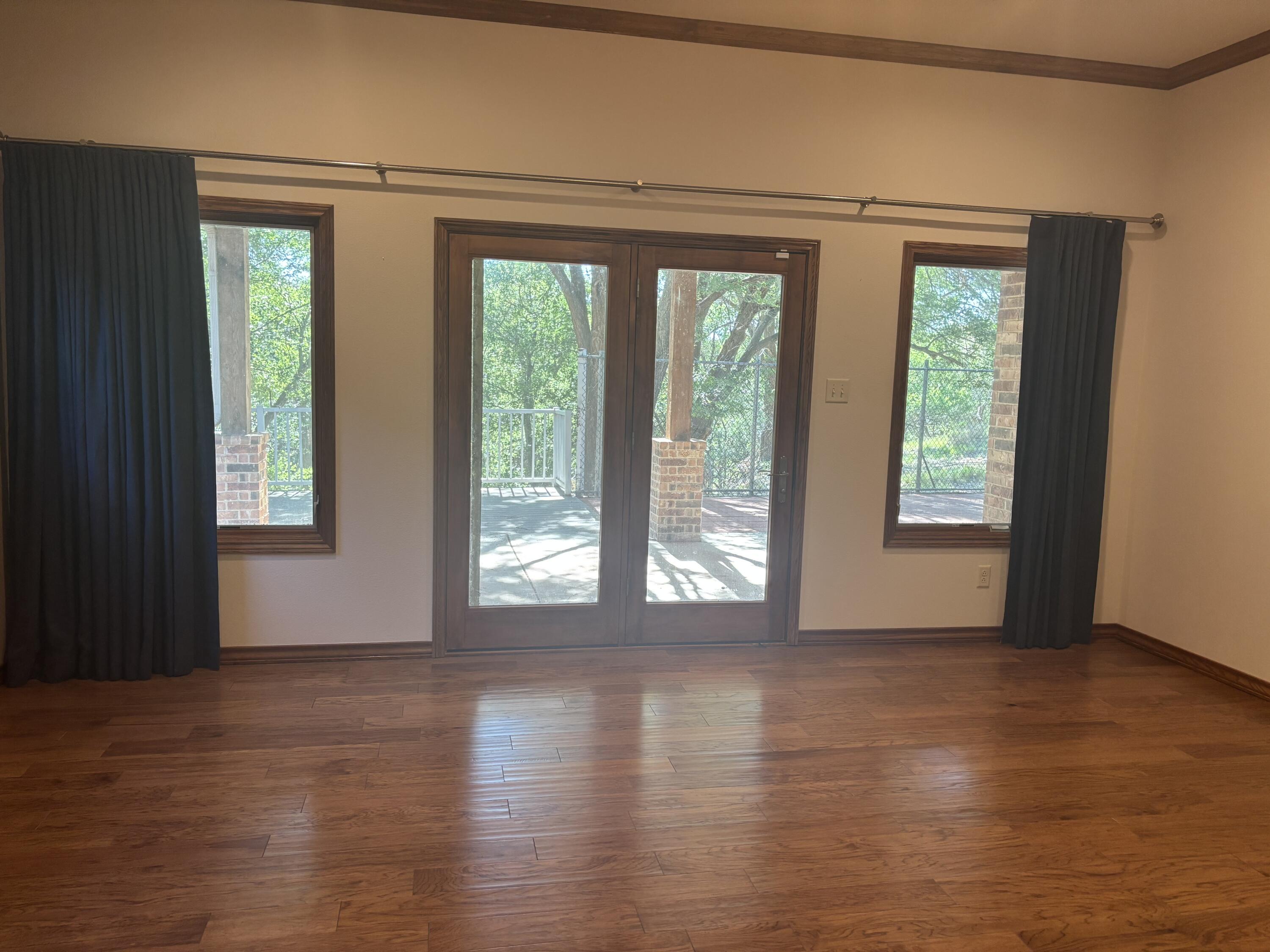 33 West Lakeshore Drive Ransom Canyon, TX 79366 - Photo 25 of 48 a view of an empty room with wooden floor and a window