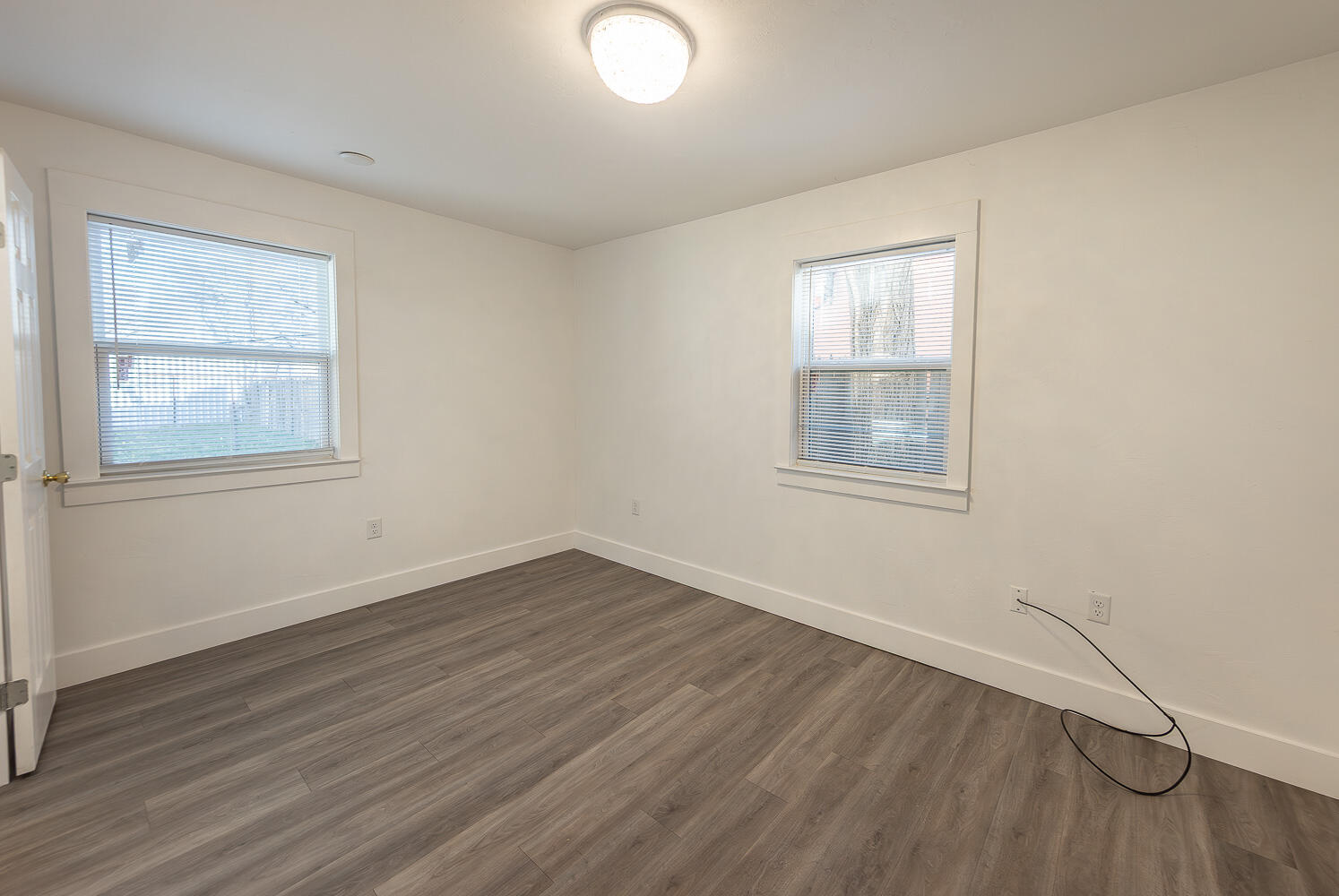 4816 40th Street Lubbock, TX 79414 - Photo 11 of 21 an empty room with wooden floor and windows