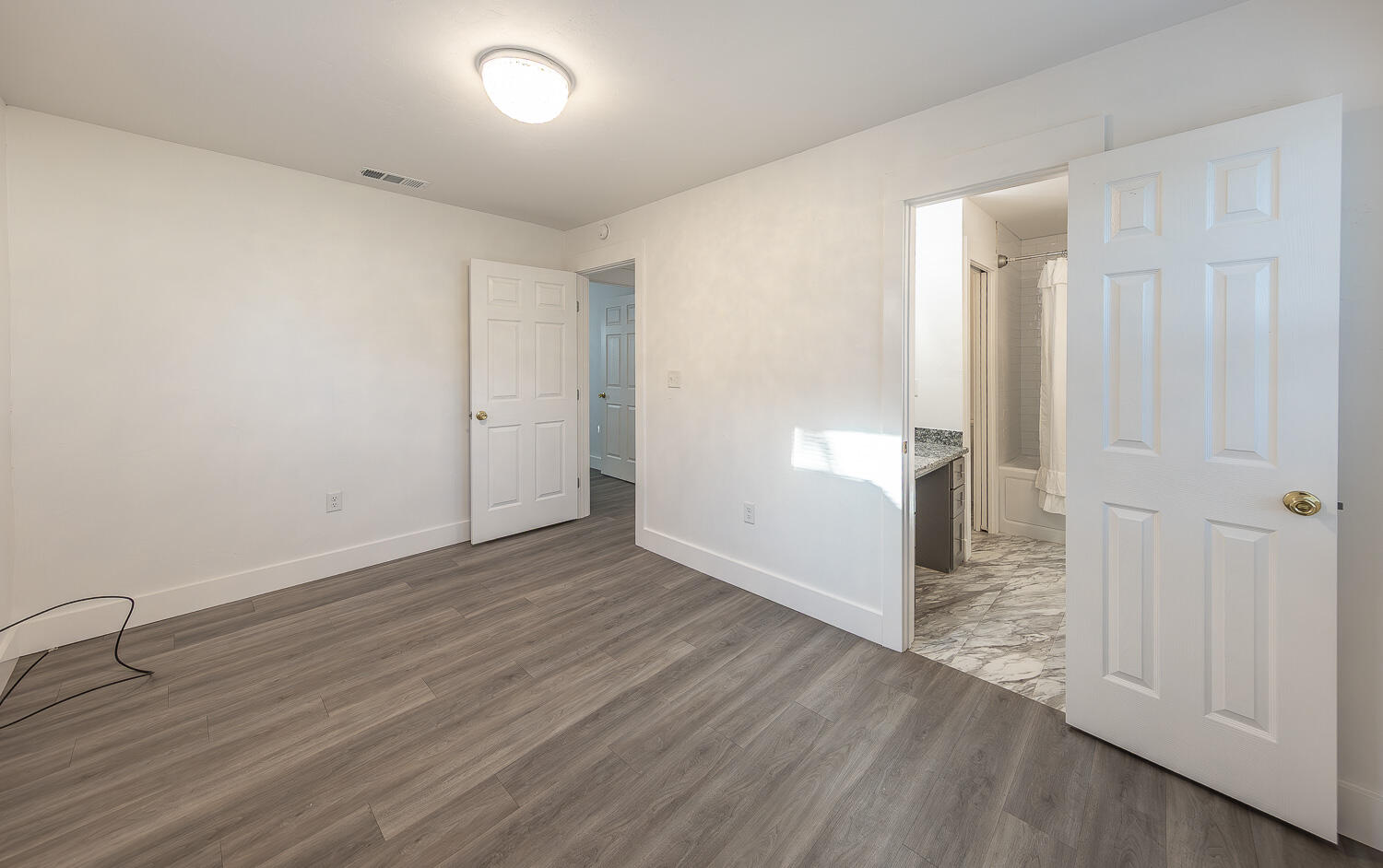4816 40th Street Lubbock, TX 79414 - Photo 12 of 21 an empty room with wooden floor and windows