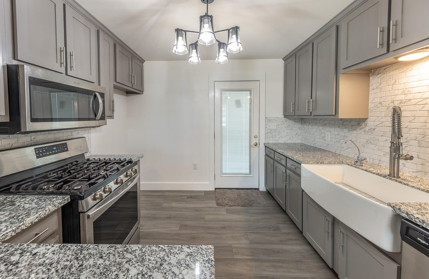 4816 40th Street Lubbock, TX 79414 - Photo 3 of 21 a kitchen with stainless steel appliances granite countertop a stove and a sink