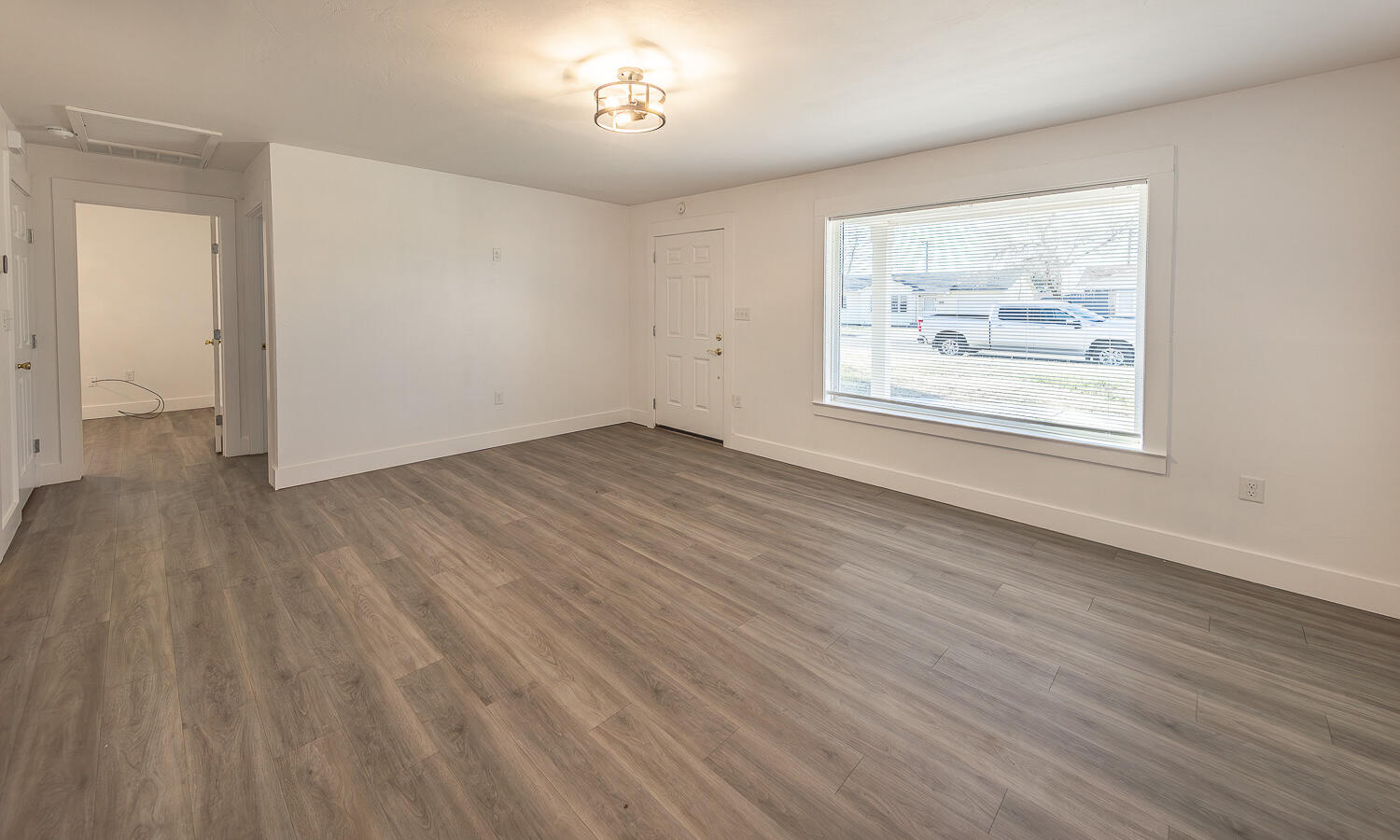 4816 40th Street Lubbock, TX 79414 - Photo 4 of 21 an empty room with wooden floor and windows