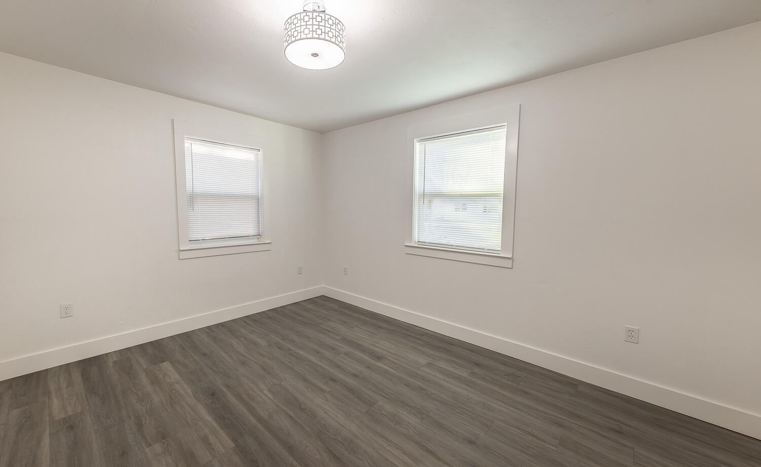 4816 40th Street Lubbock, TX 79414 - Photo 9 of 21 an empty room with wooden floor and windows
