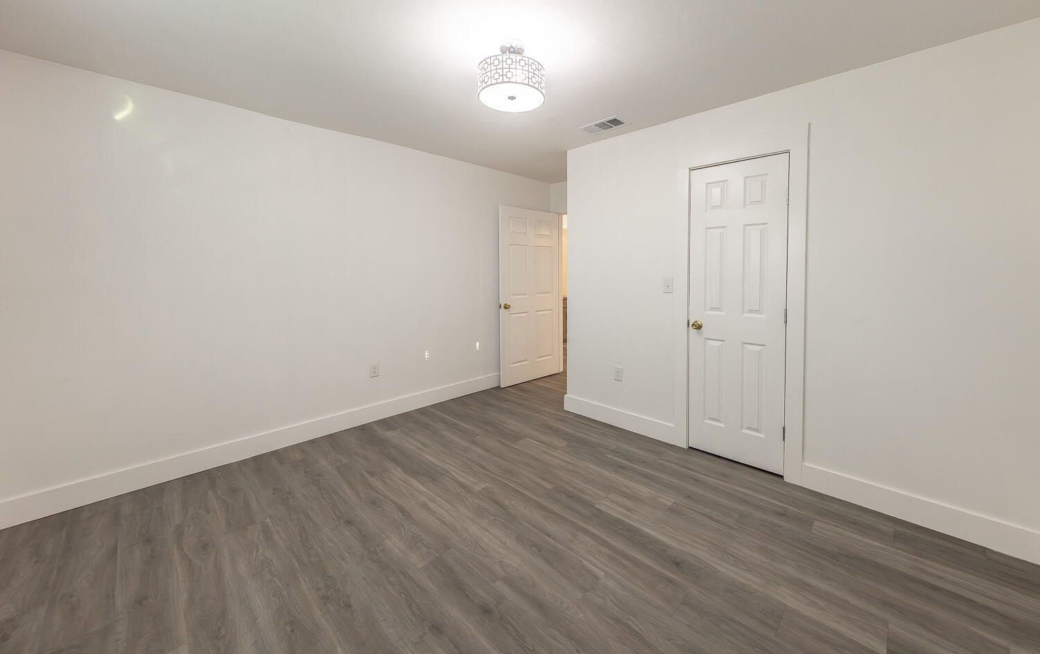 4816 40th Street Lubbock, TX 79414 - Photo 10 of 21 a view of an empty room with wooden floor