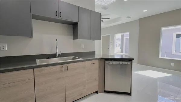 a kitchen with cabinets and window