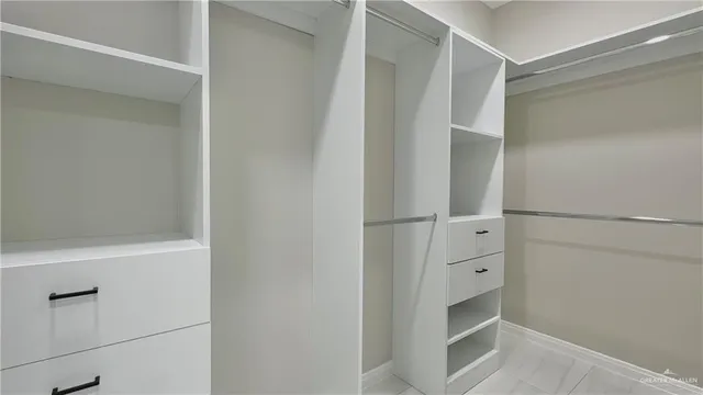 a view of walk in closet with cabinet