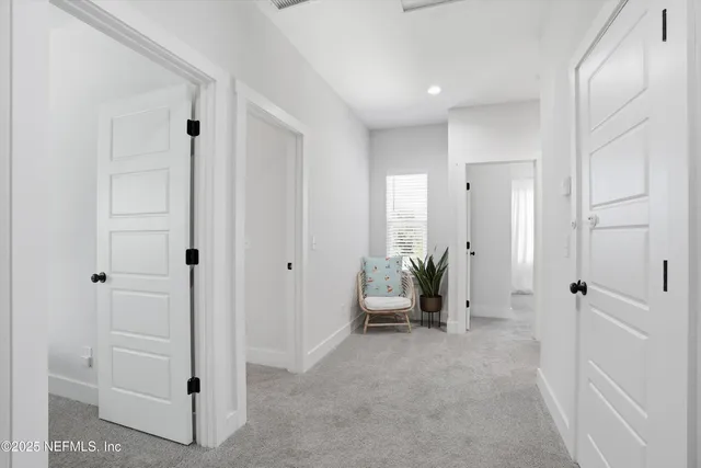 a large bed sitting in a bedroom next to a window