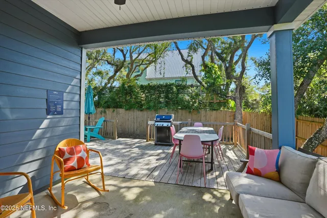 a view of an outdoor sitting area with furniture and wooden deck