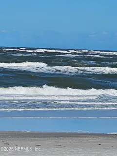 front view of a house with a chairs and table in a patio