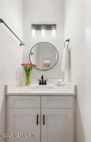 a bathroom with a toilet a sink and a mirror