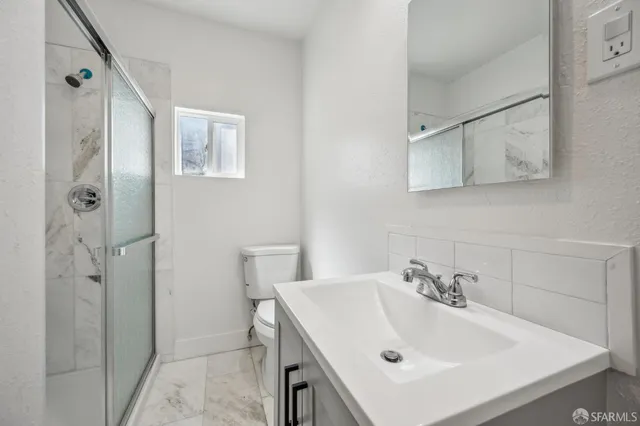 a bathroom with a sink toilet and shower