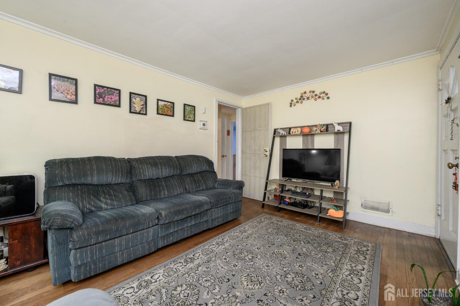 4 Homestead Avenue Avenel, NJ 07001 - Photo 5 of 40 a living room with furniture and a flat screen tv