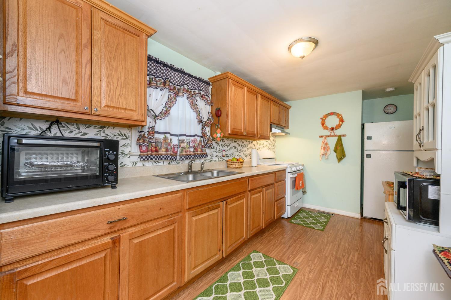 4 Homestead Avenue Avenel, NJ 07001 - Photo 7 of 40 a kitchen with stainless steel appliances granite countertop a refrigerator and a stove top oven