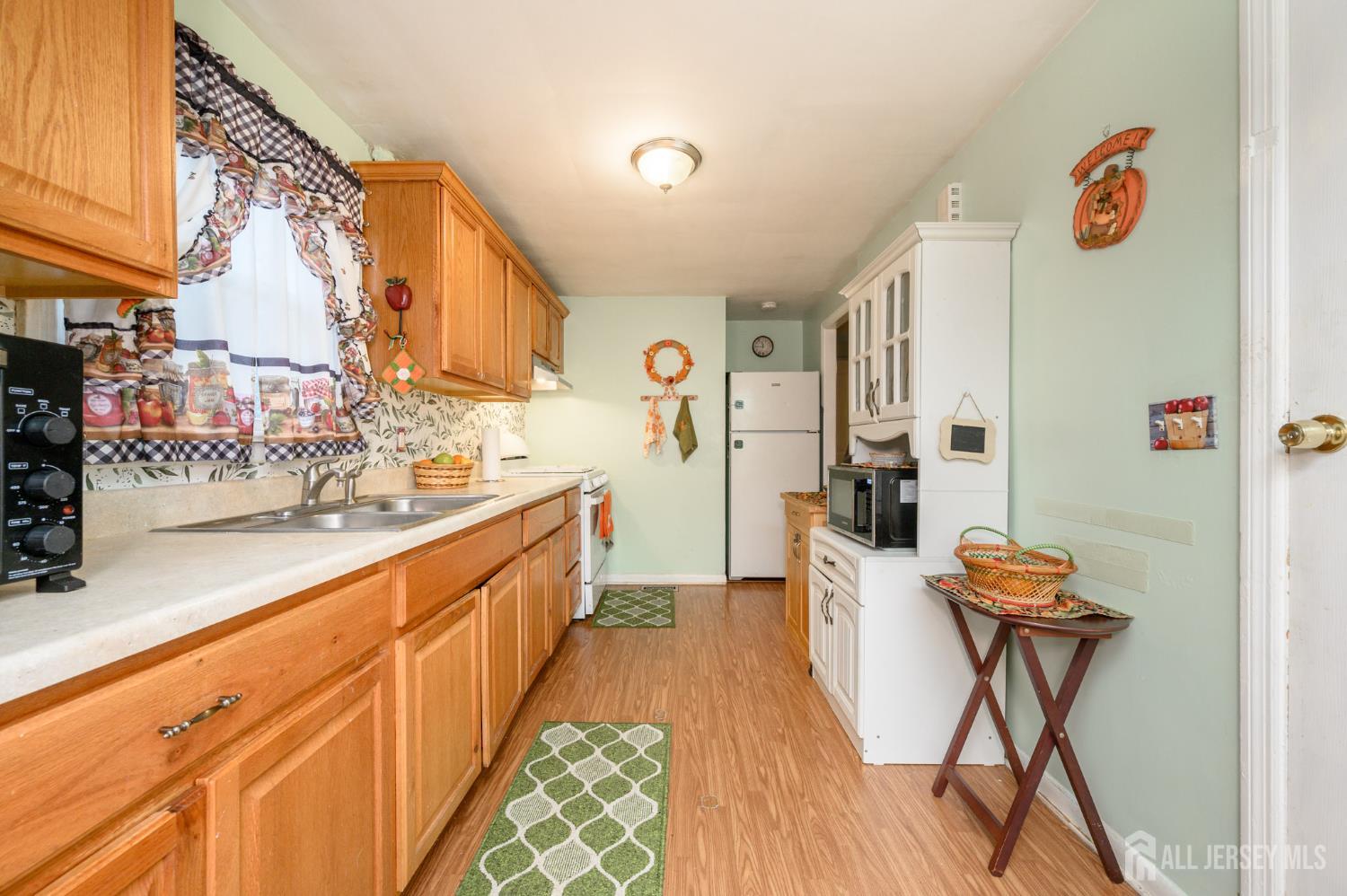 4 Homestead Avenue Avenel, NJ 07001 - Photo 8 of 40 a large kitchen with stainless steel appliances granite countertop a sink and cabinets